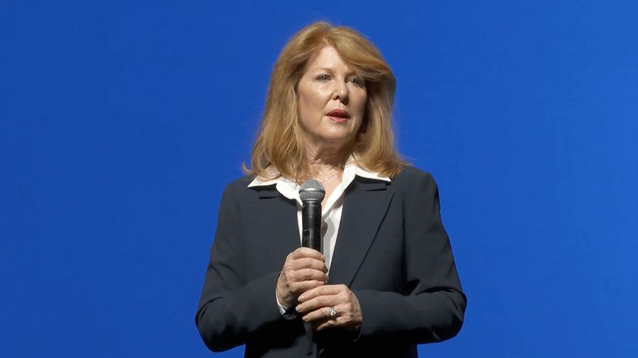 Anne McGinness Kearse in front of a Blue Background