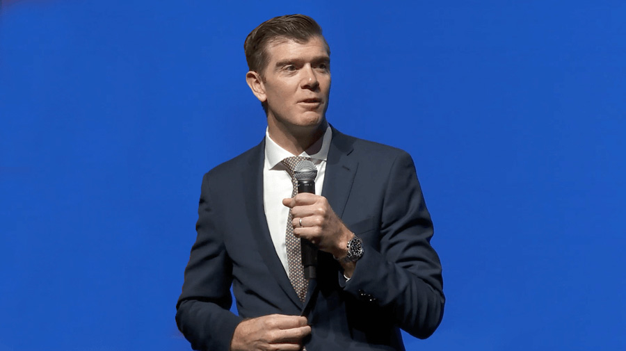 Daniel P. Blouin in front of a Blue Background